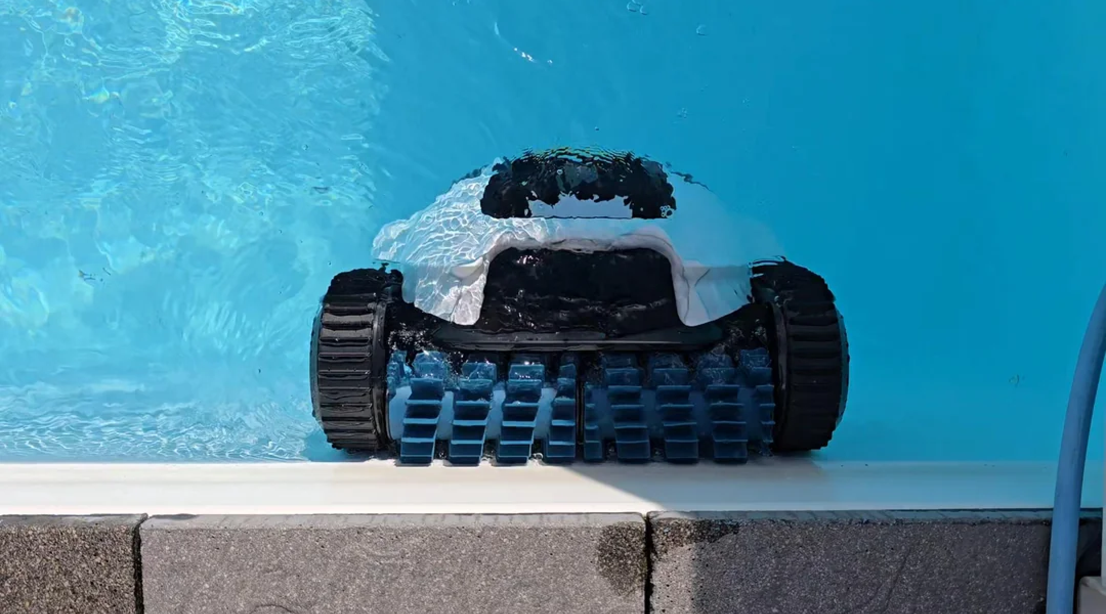 Mammotion SPINO E1 robotic pool cleaner working along the edge of the pool